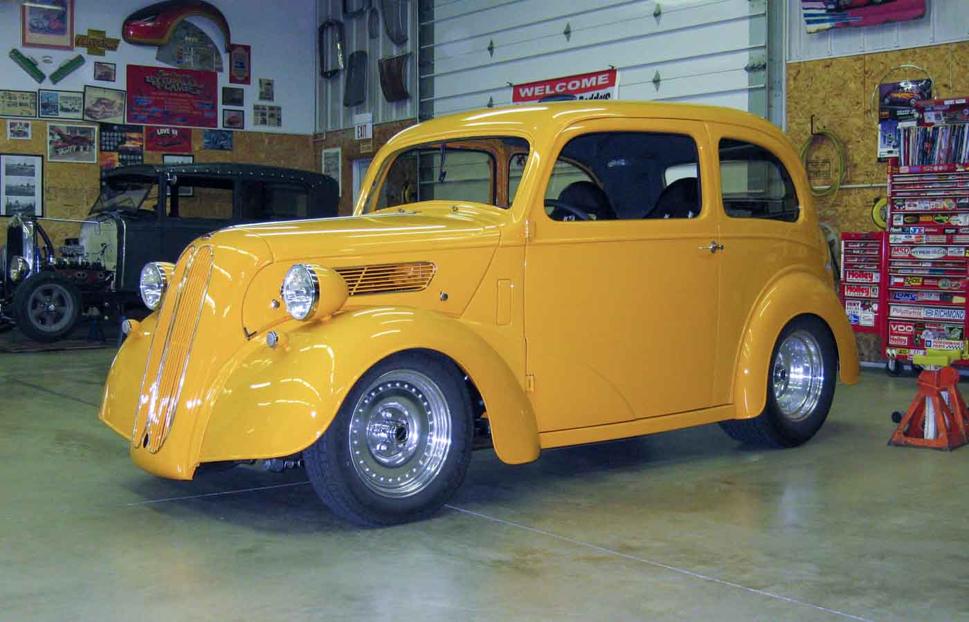 Yellow Anglia hot rod in the shop